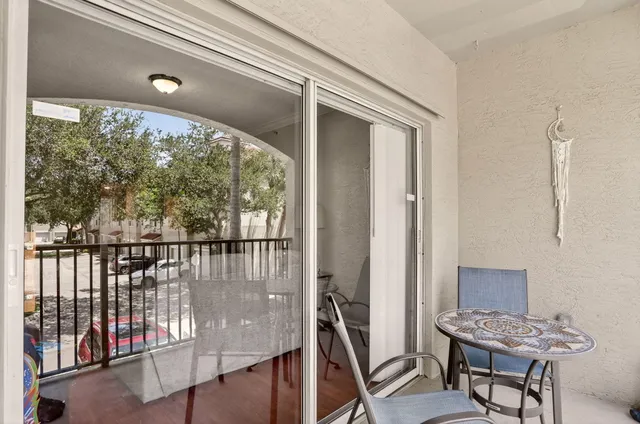 a view of a balcony with chairs