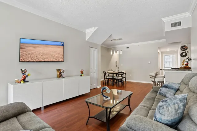 a living room with furniture and wooden floor