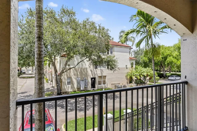a view of a balcony with wooden fence