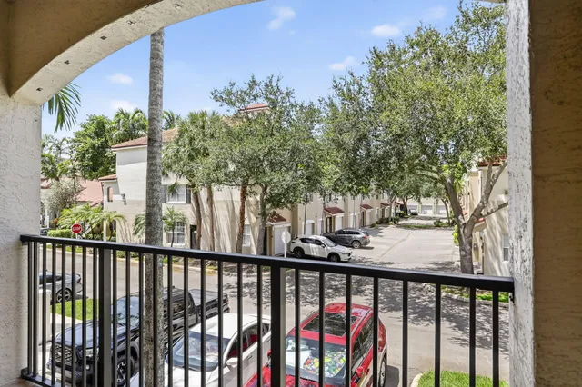 a view of a balcony with wooden fence and floor
