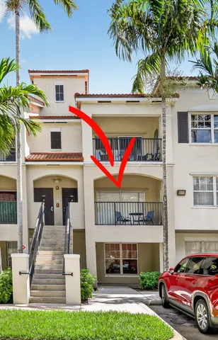 a front view of a house with a garden and parking space