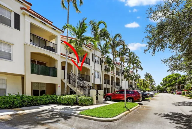 a front view of a house with a garden and parking space