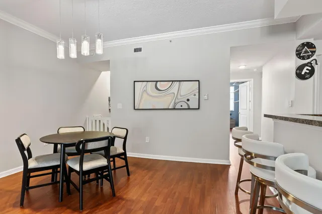 a view of a dining room with furniture and wooden floor