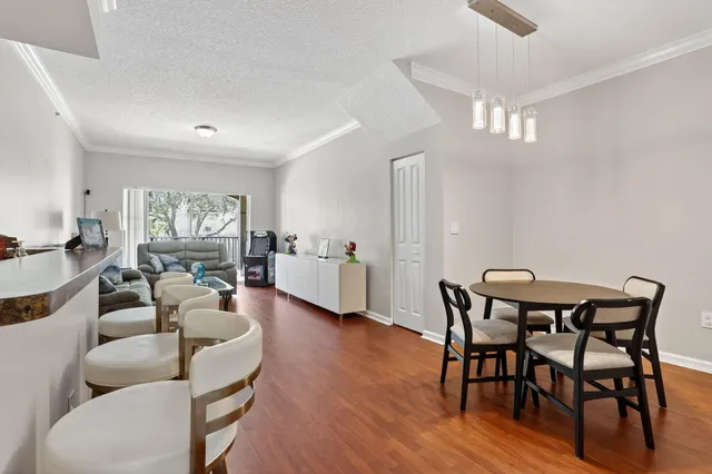 a view of a dining room with furniture and wooden floor