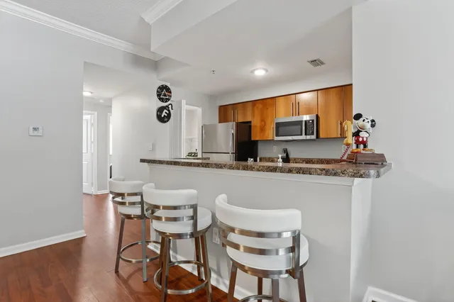 a kitchen with stainless steel appliances kitchen island granite countertop a sink and cabinets