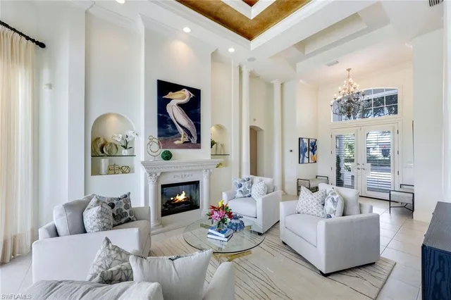 a dining room with furniture a chandelier and window
