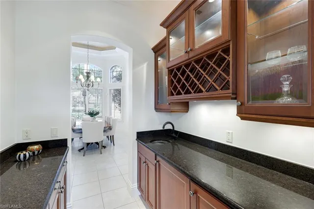 a kitchen with stainless steel appliances kitchen island granite countertop a stove a sink a refrigerator and a refrigerator with wooden floor