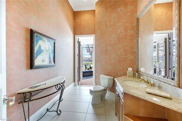 a spacious bedroom with a large bed and a chandelier