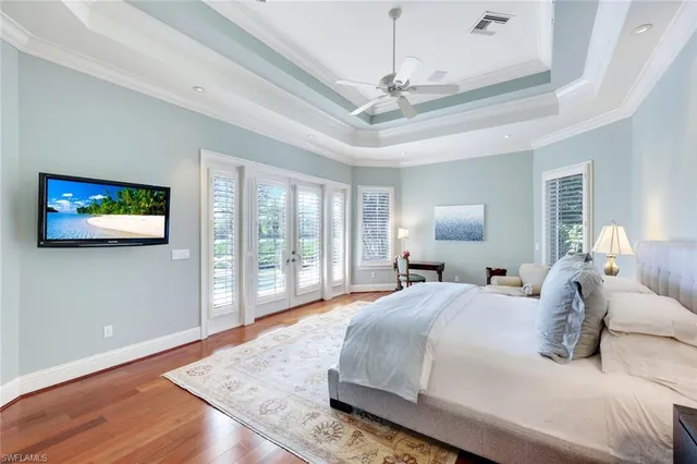 a spacious bathroom with a double vanity sink a large mirror a bathtub and shower