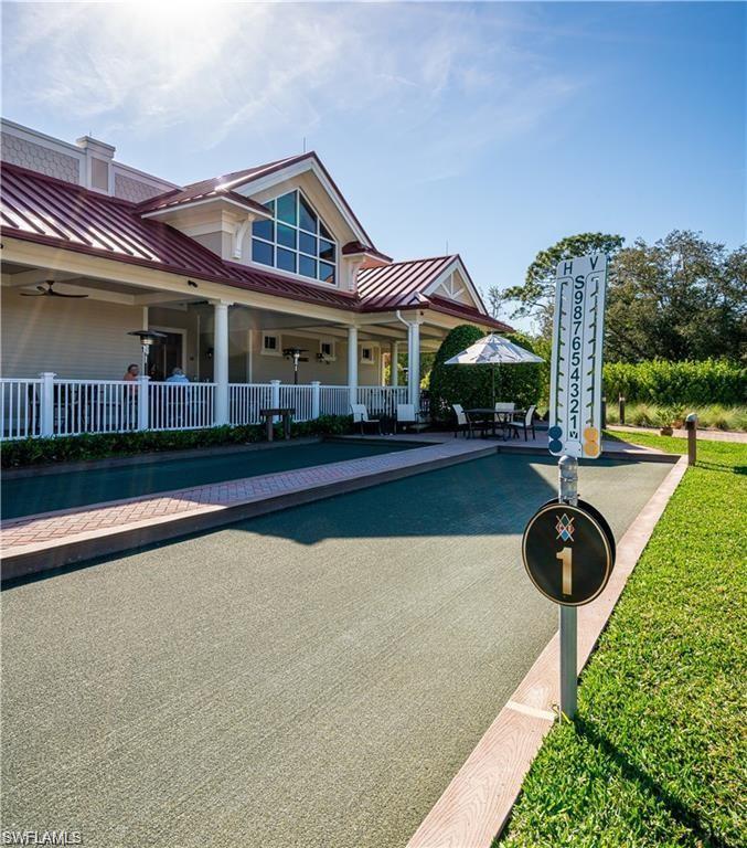 1483 Gormican Lane Naples, FL 34110 - Photo 6 of 11 a front view of a house with yard and glass windows