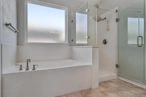 a bathroom with a bathtub and a shower
