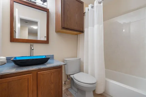 a bathroom with a toilet a sink and bathtub