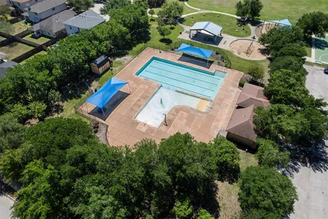 an aerial view of a house with a yard basket ball court and outdoor seating