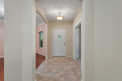 a view of a hallway with wooden shelves