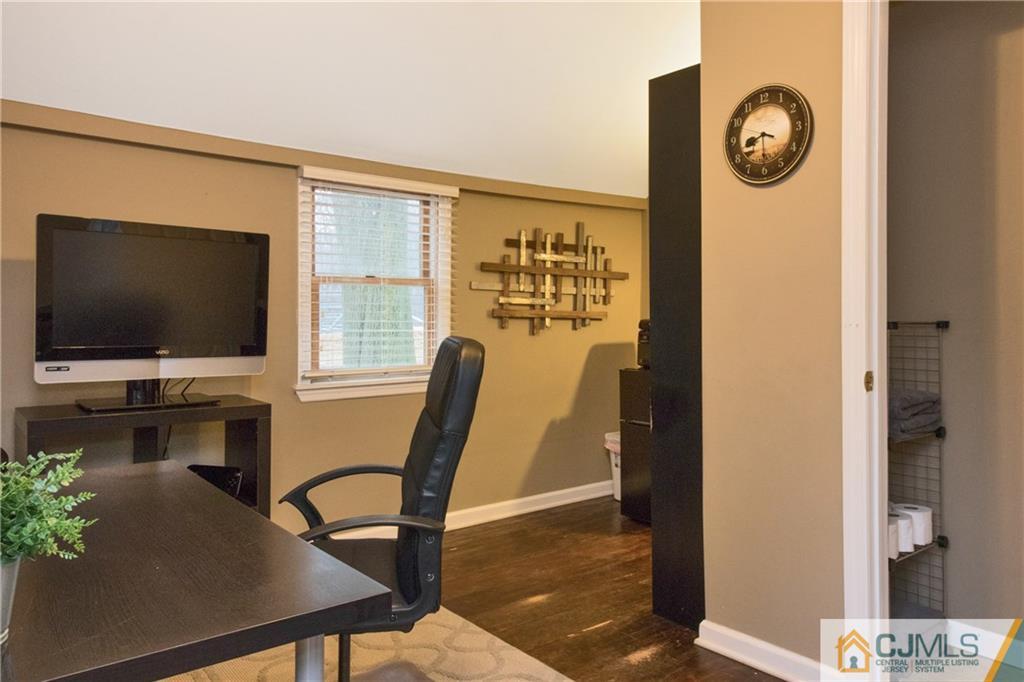 19 Reids Hill Road Morganville, NJ 07751 - Photo 11 of 24 a living room with furniture and a flat screen tv