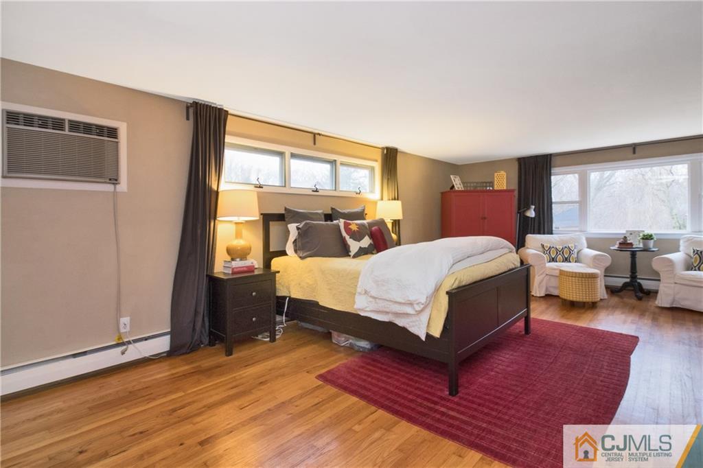 19 Reids Hill Road Morganville, NJ 07751 - Photo 13 of 24 a bedroom with a bed couch and a window