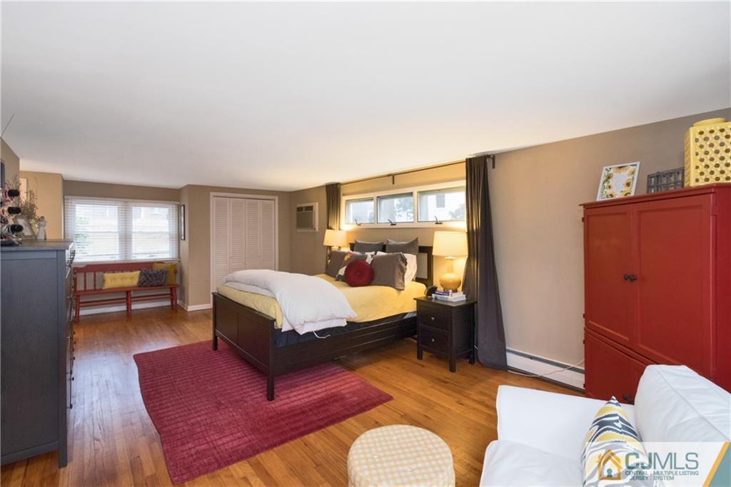 19 Reids Hill Road Morganville, NJ 07751 - Photo 14 of 24 a bedroom with a bed and wooden floor