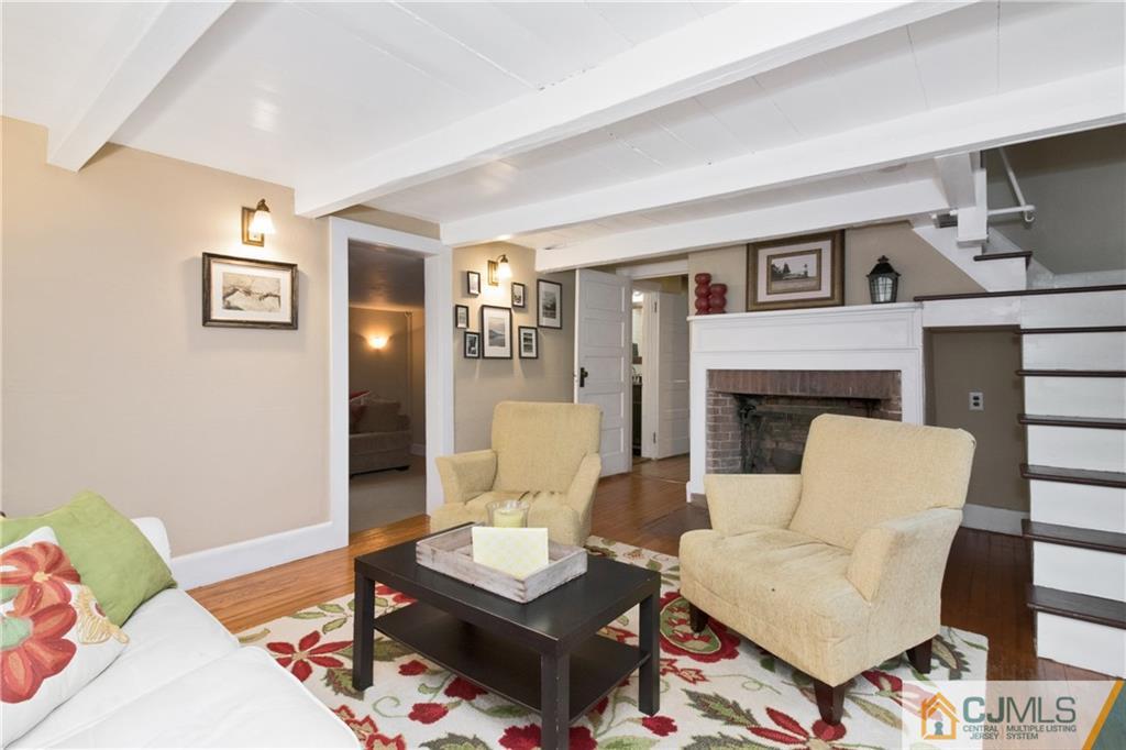 19 Reids Hill Road Morganville, NJ 07751 - Photo 5 of 24 a living room with furniture and a fireplace