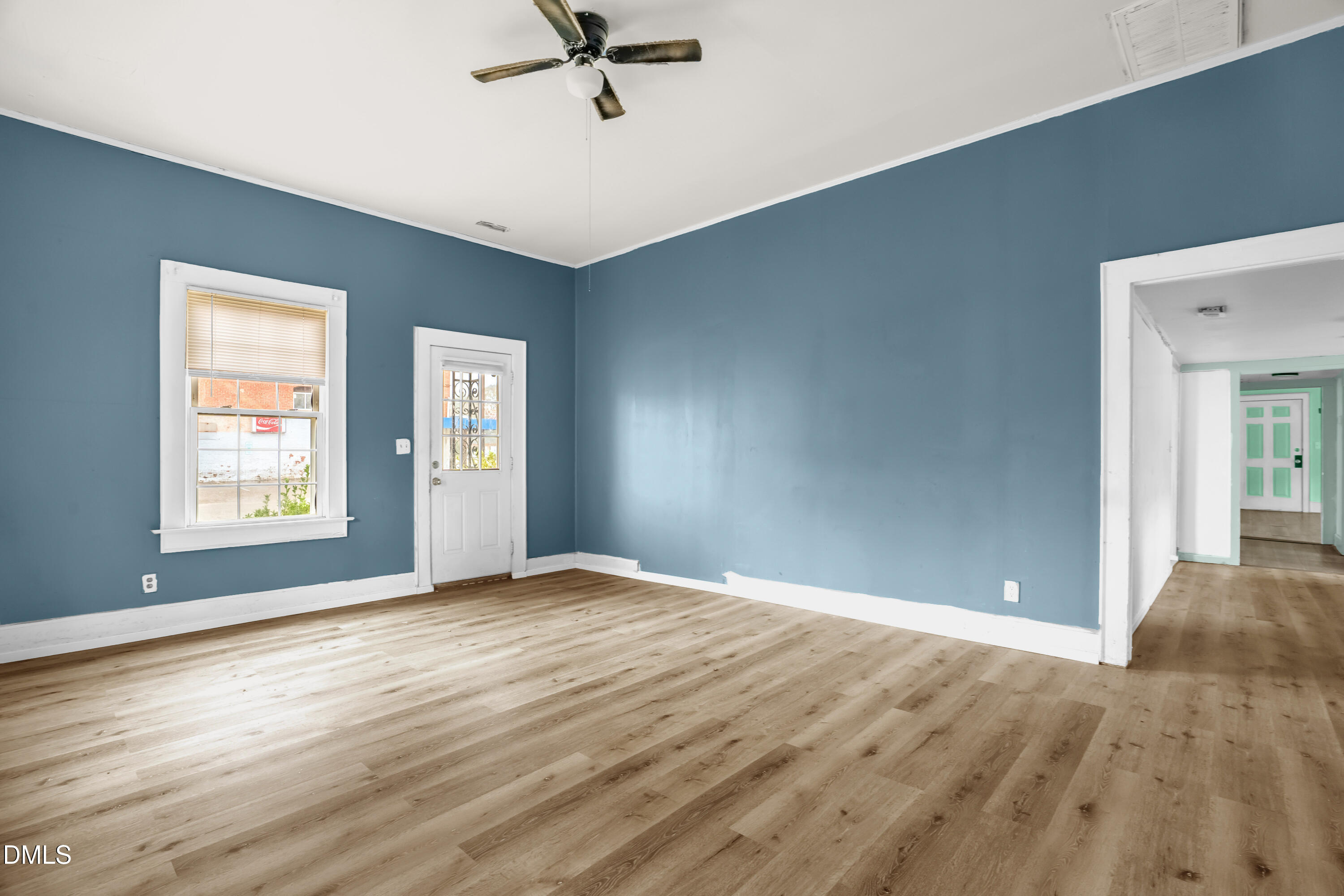 201 East H Street Erwin, NC 28339 - Photo 11 of 23 a view of empty room with wooden floor and fan