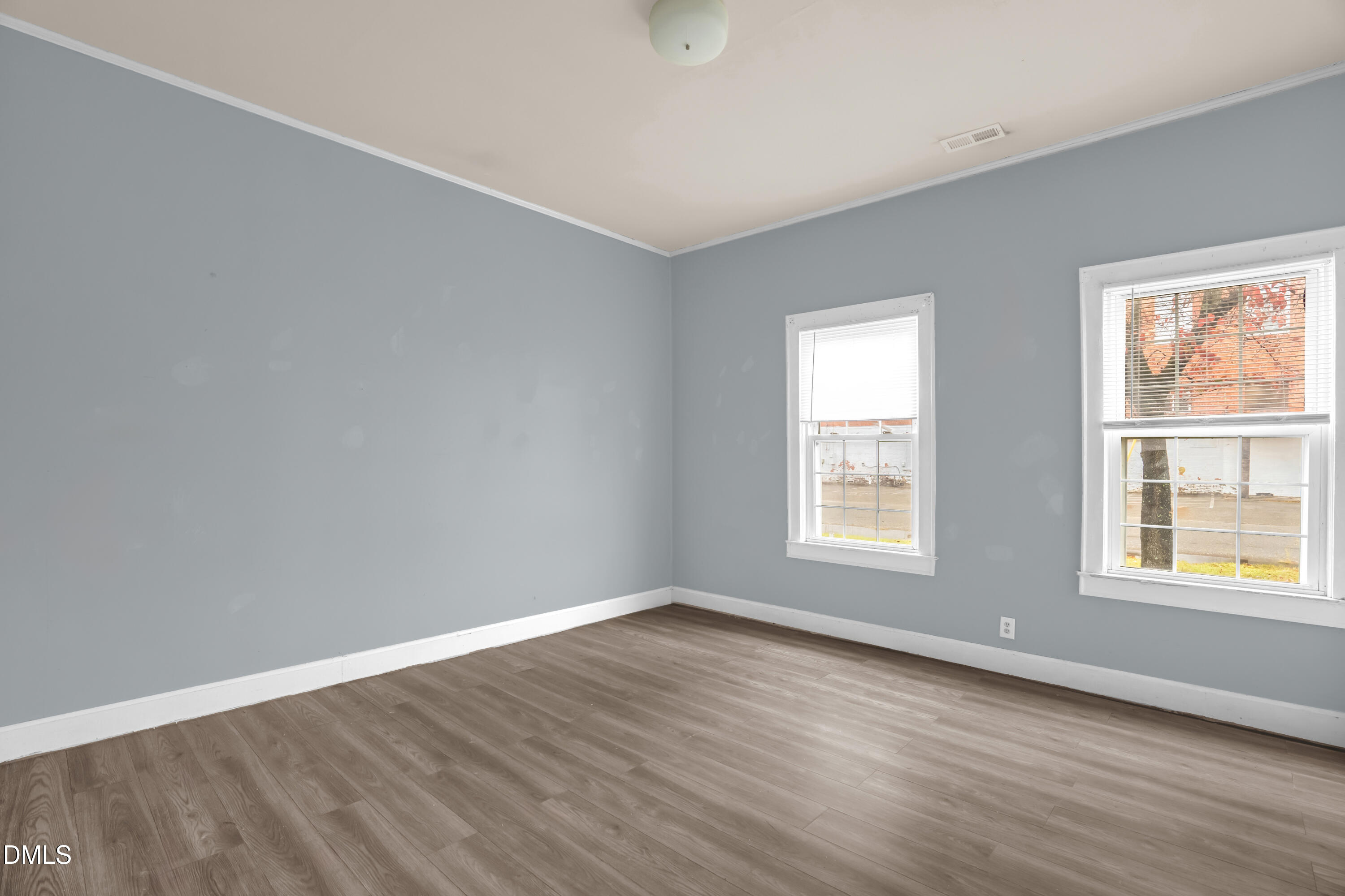 201 East H Street Erwin, NC 28339 - Photo 14 of 23 a view of an empty room with wooden floor and a window