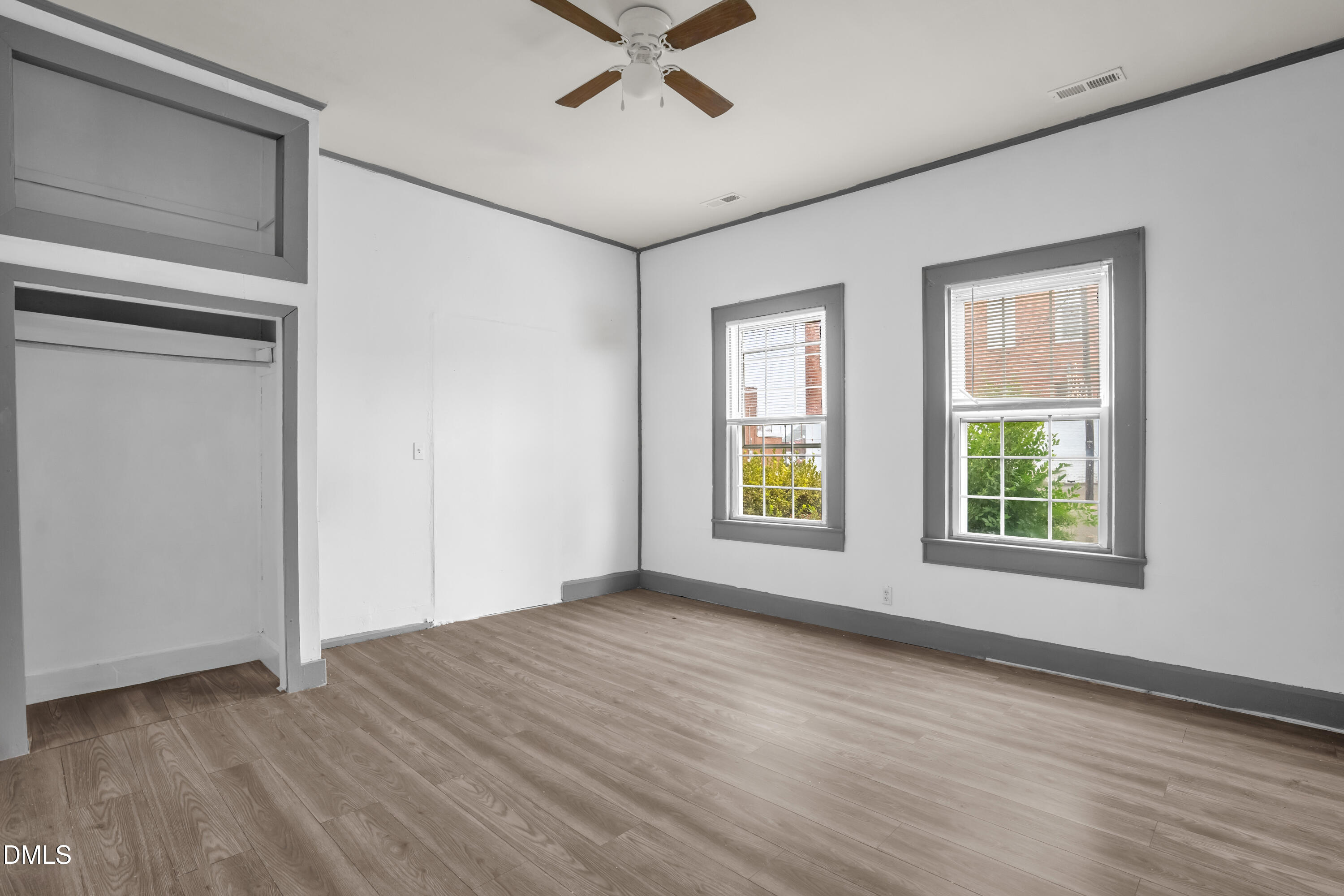 201 East H Street Erwin, NC 28339 - Photo 15 of 23 a view of an empty room with a window and wooden floor