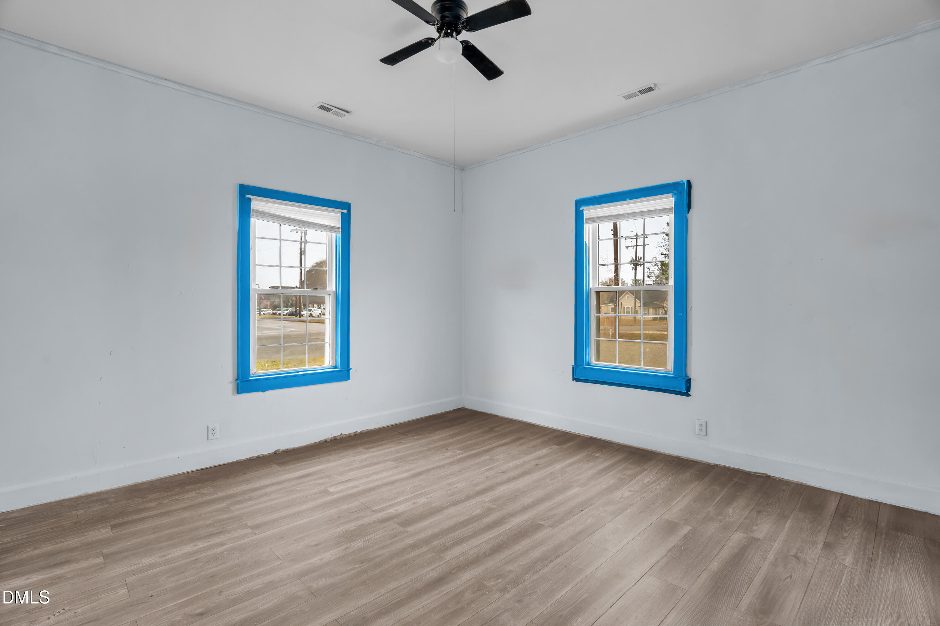 201 East H Street Erwin, NC 28339 - Photo 19 of 23 a view of an empty room with a window and wooden floor