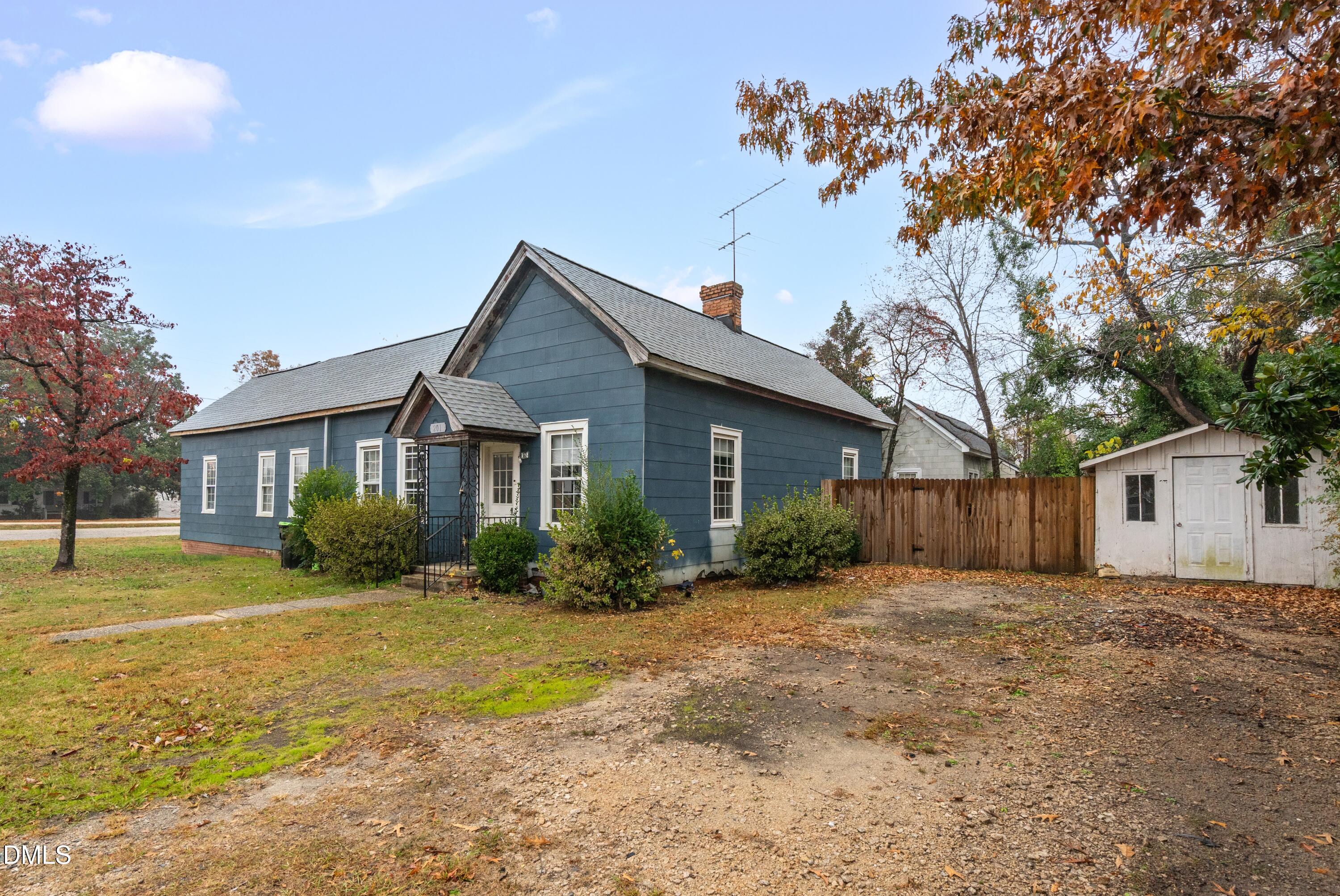 201 East H Street Erwin, NC 28339 - Photo 2 of 23 a view of a yard in front of a house with large trees