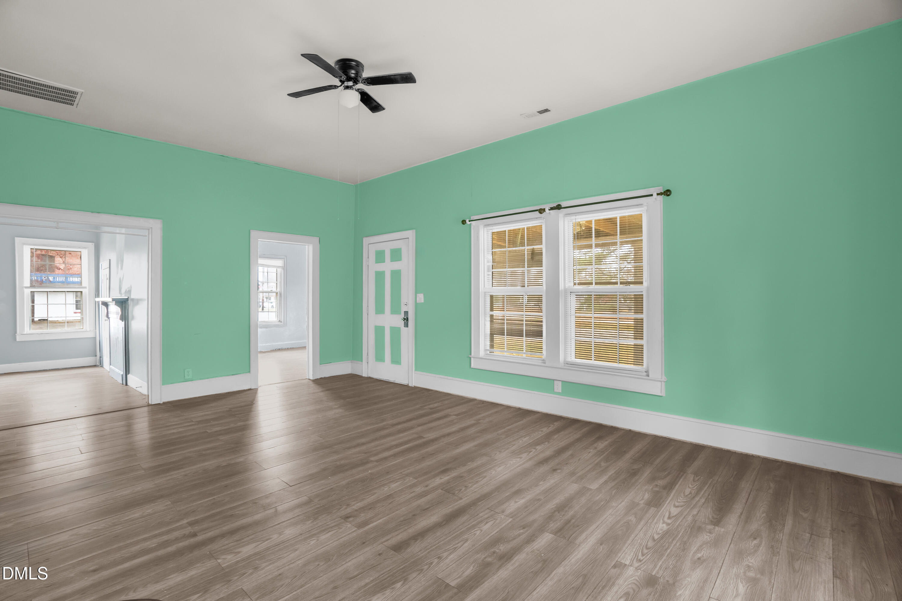 201 East H Street Erwin, NC 28339 - Photo 3 of 23 a view of an empty room with a window and wooden floor