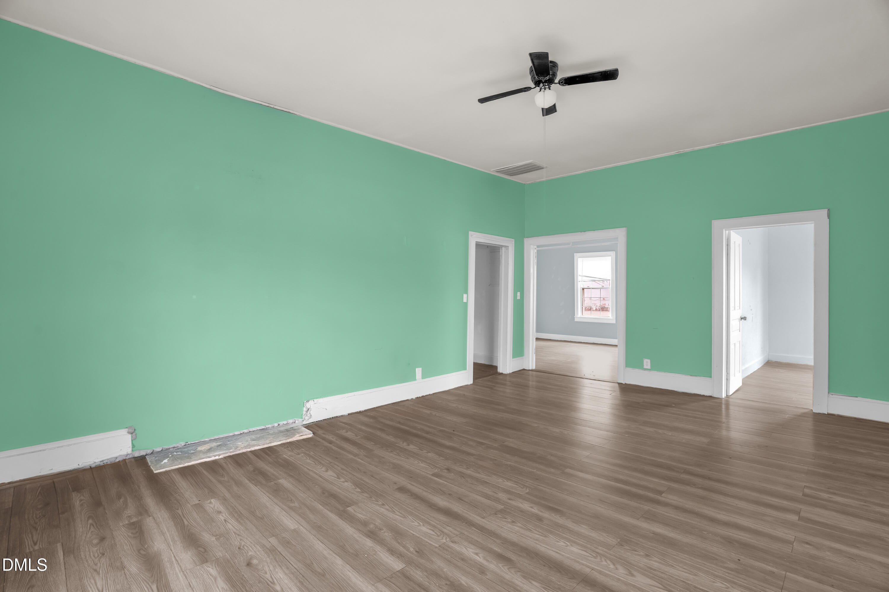 201 East H Street Erwin, NC 28339 - Photo 5 of 23 a view of an empty room with window and wooden floor