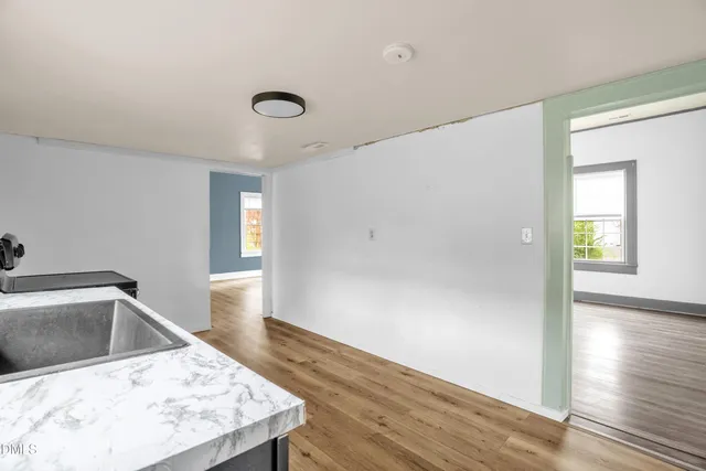 a view of a kitchen cabinets a sink and dishwasher with wooden floor