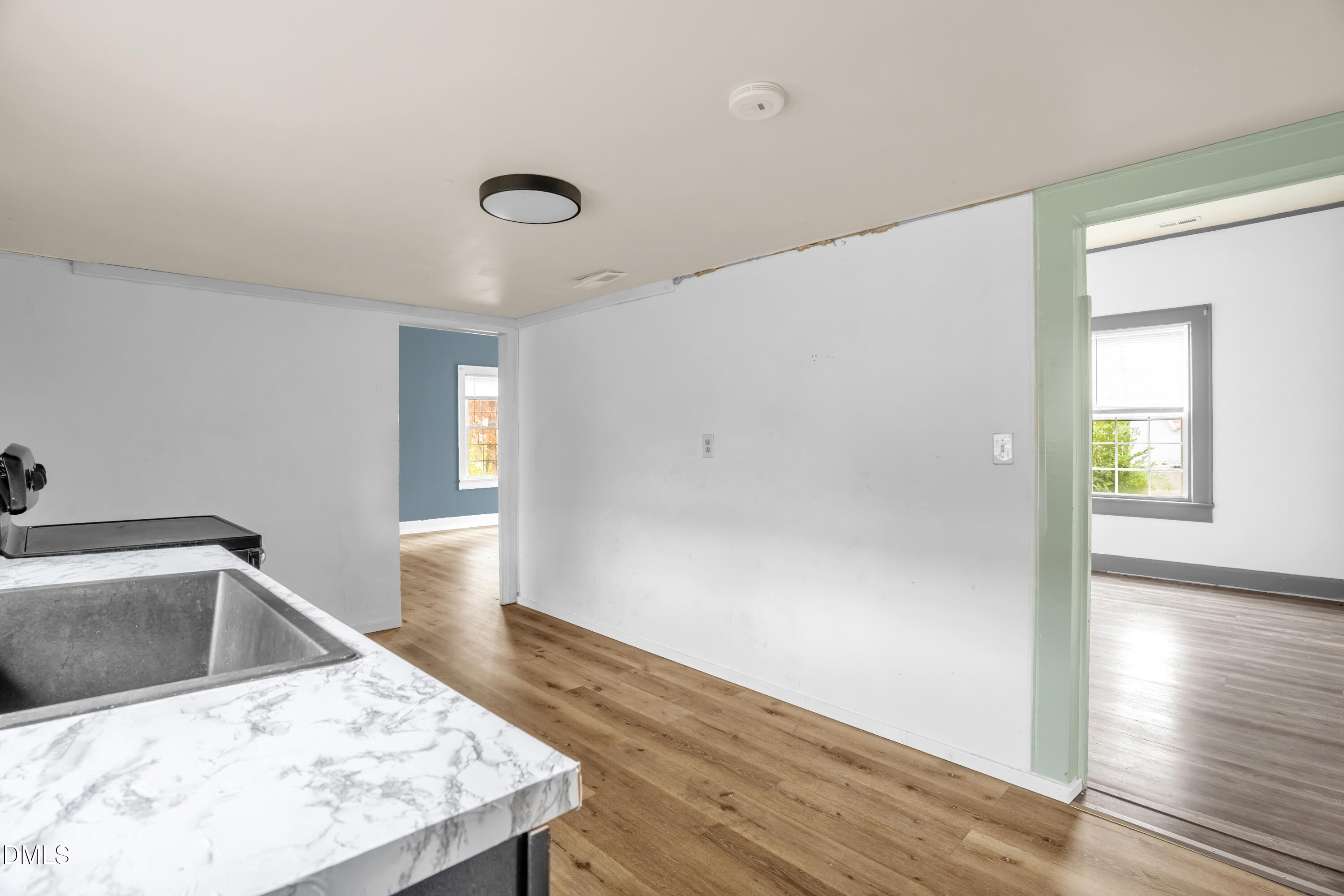 201 East H Street Erwin, NC 28339 - Photo 7 of 23 a view of a kitchen cabinets a sink and dishwasher with wooden floor