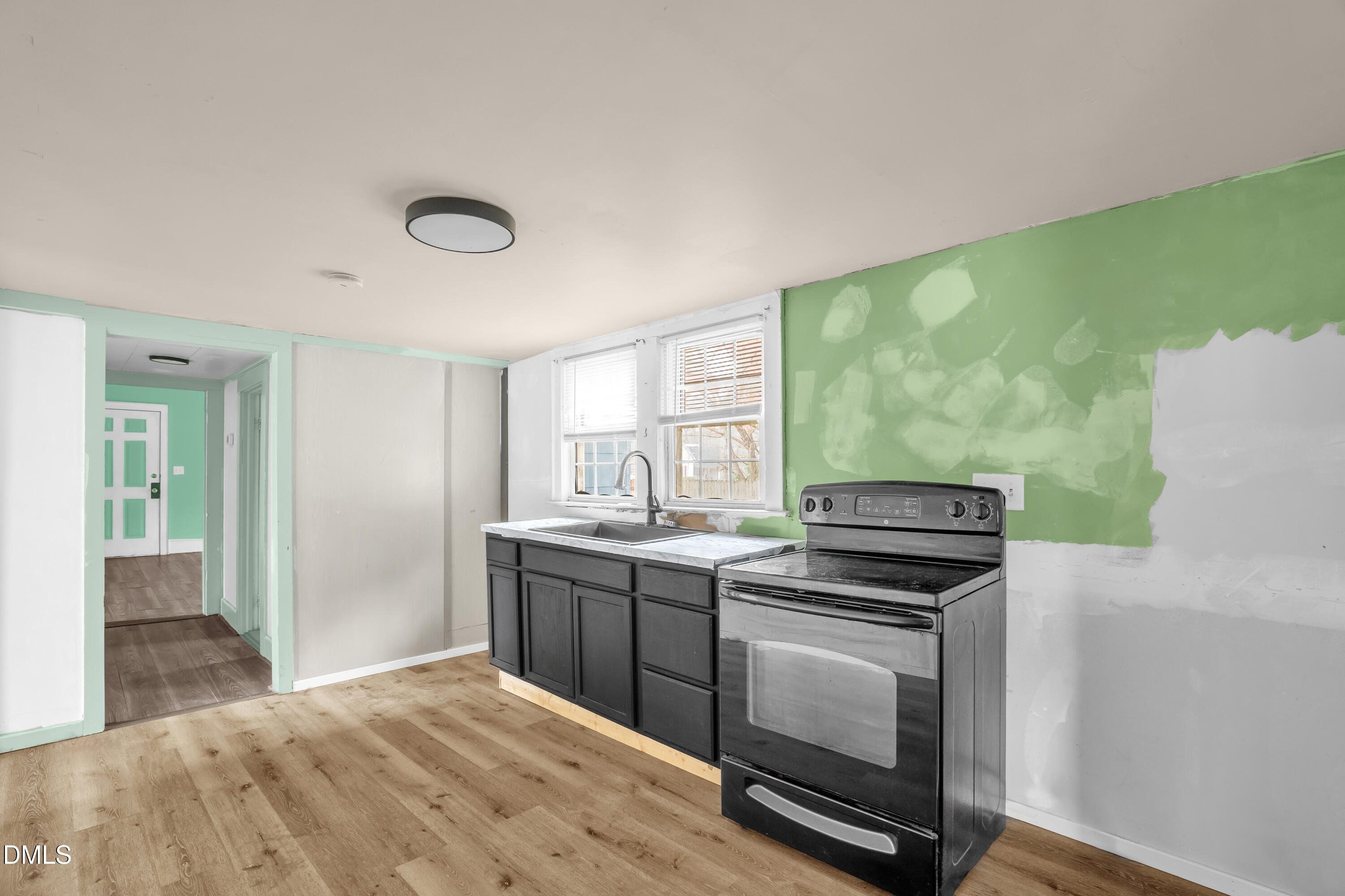 201 East H Street Erwin, NC 28339 - Photo 9 of 23 a kitchen with a stove and a microwave