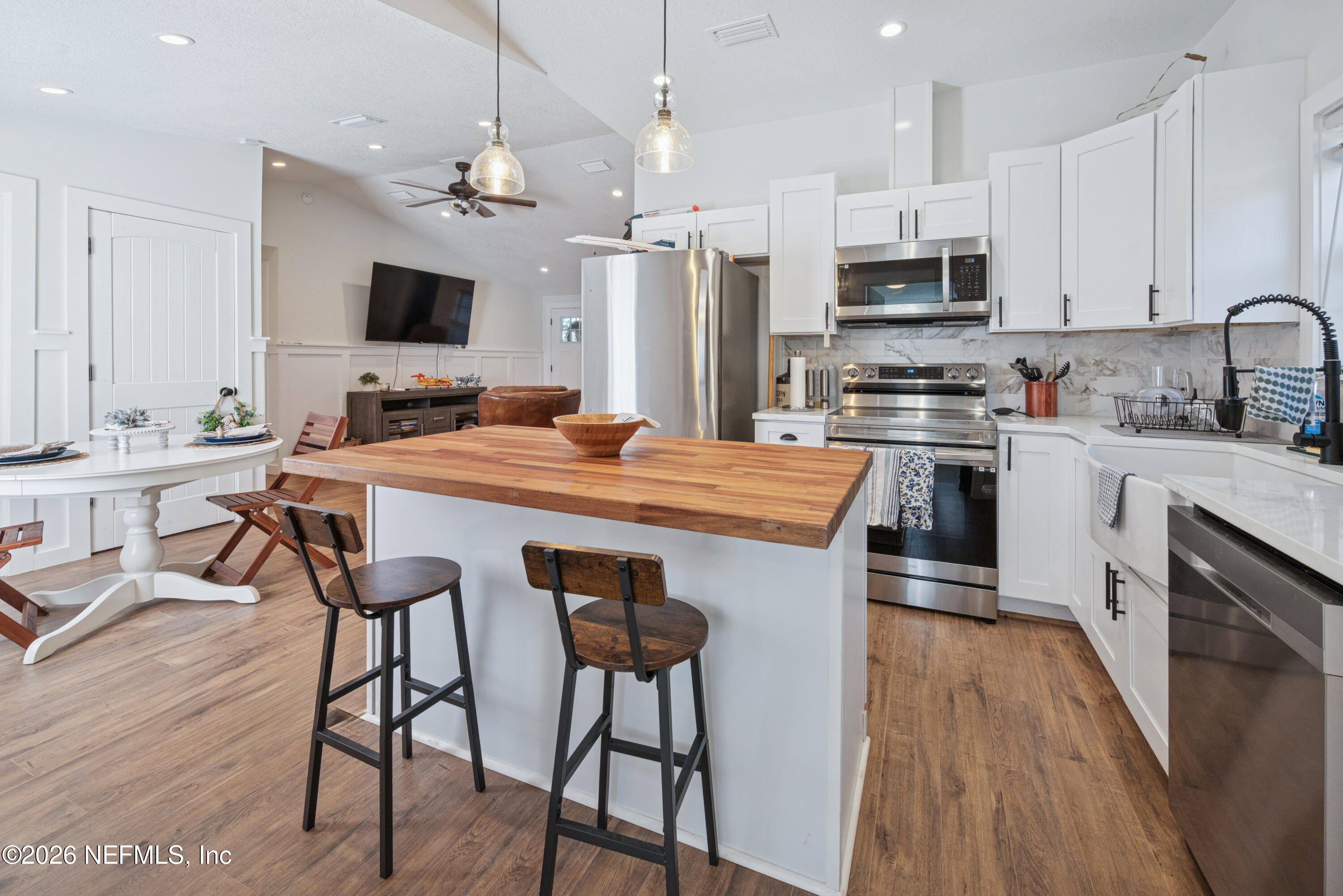 23779 Northwest 225a Road, Unit COUNTY Starke, FL 32091 - Photo 17 of 73 a kitchen with stainless steel appliances a stove top oven a sink dishwasher and a refrigerator with wooden floor