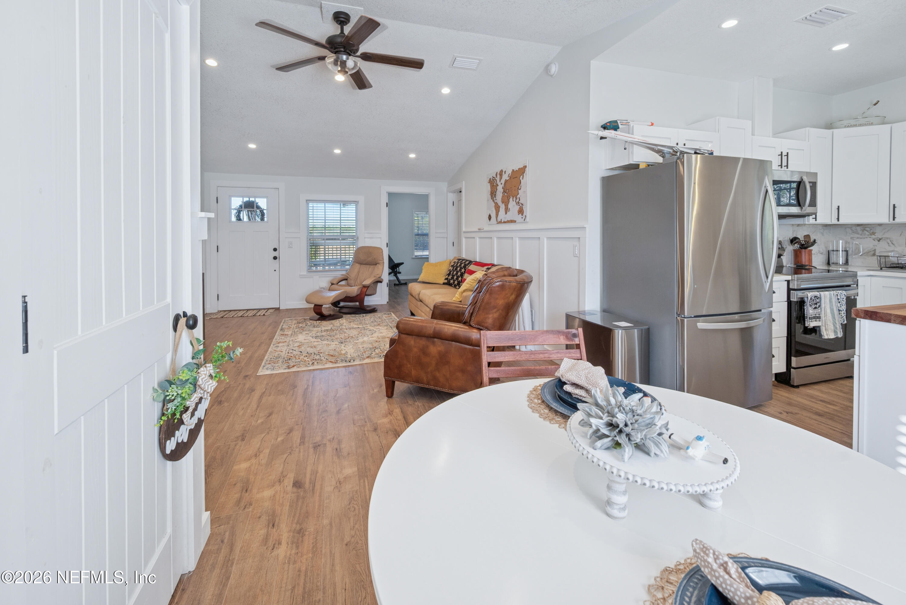 23779 Northwest 225a Road, Unit COUNTY Starke, FL 32091 - Photo 19 of 73 a kitchen with stainless steel appliances a dining table and chairs