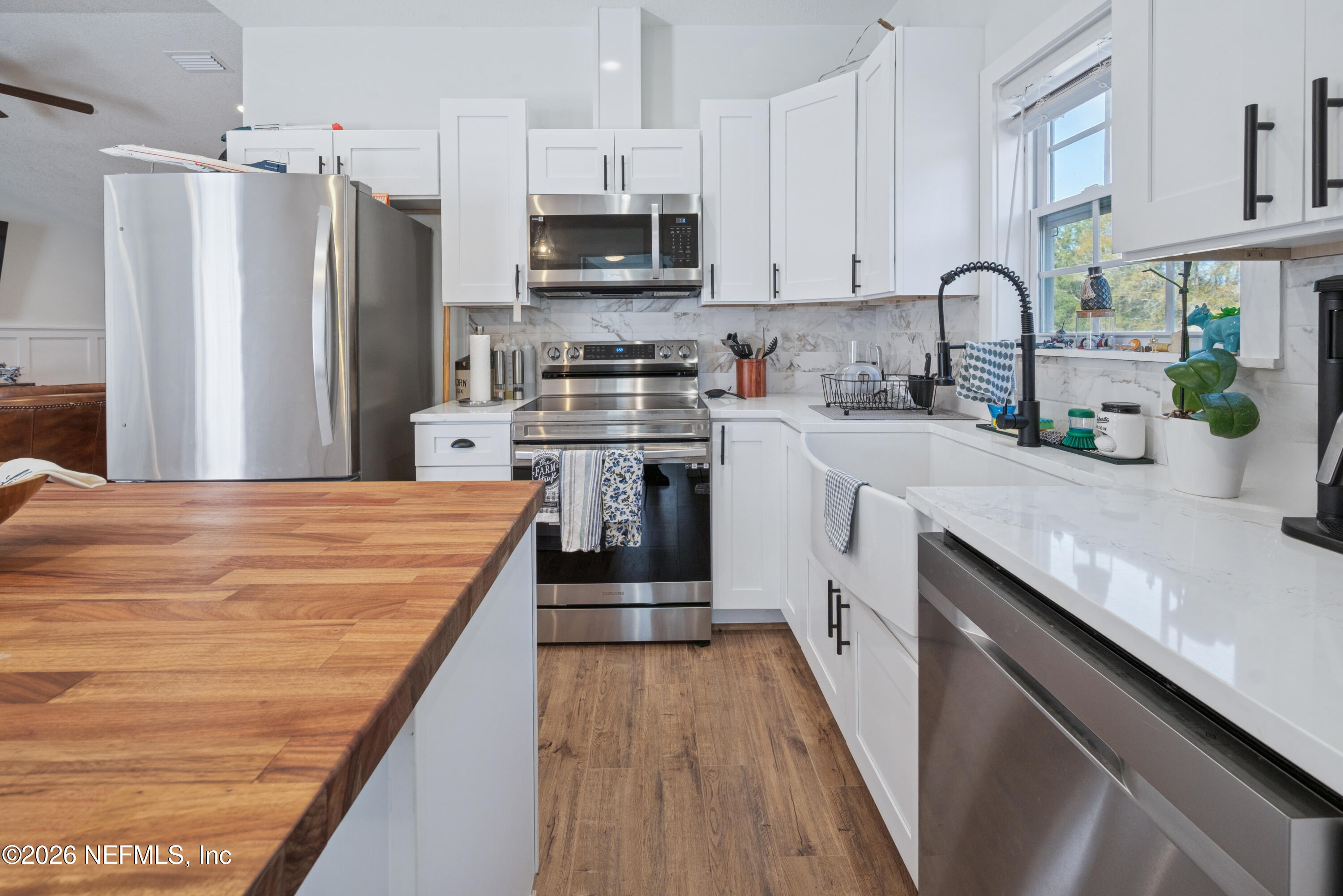 23779 Northwest 225a Road, Unit COUNTY Starke, FL 32091 - Photo 23 of 73 a kitchen with stainless steel appliances a sink dishwasher a refrigerator a stove top oven a sink and dishwasher