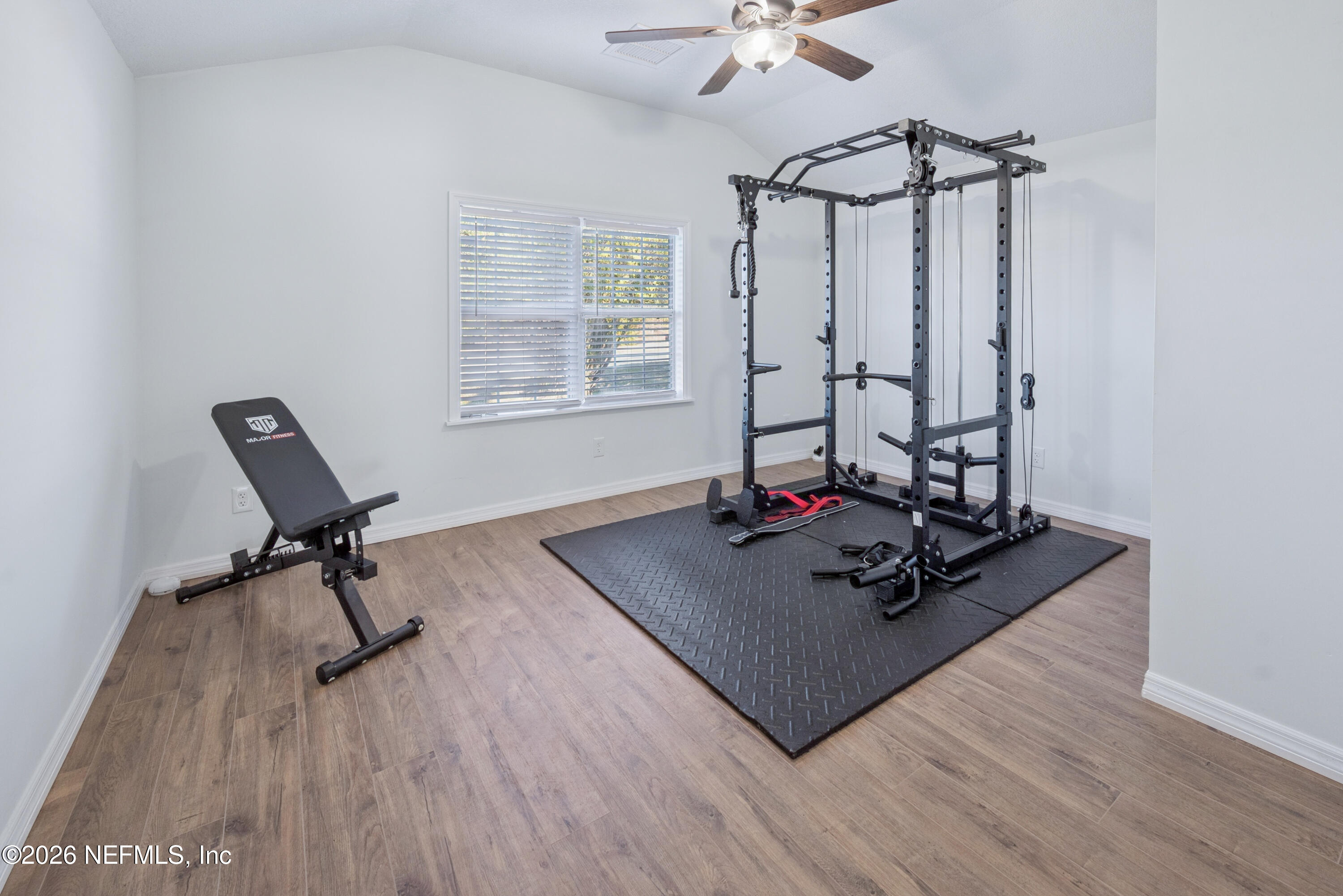23779 Northwest 225a Road, Unit COUNTY Starke, FL 32091 - Photo 25 of 73 a room with a table chairs and wooden floor