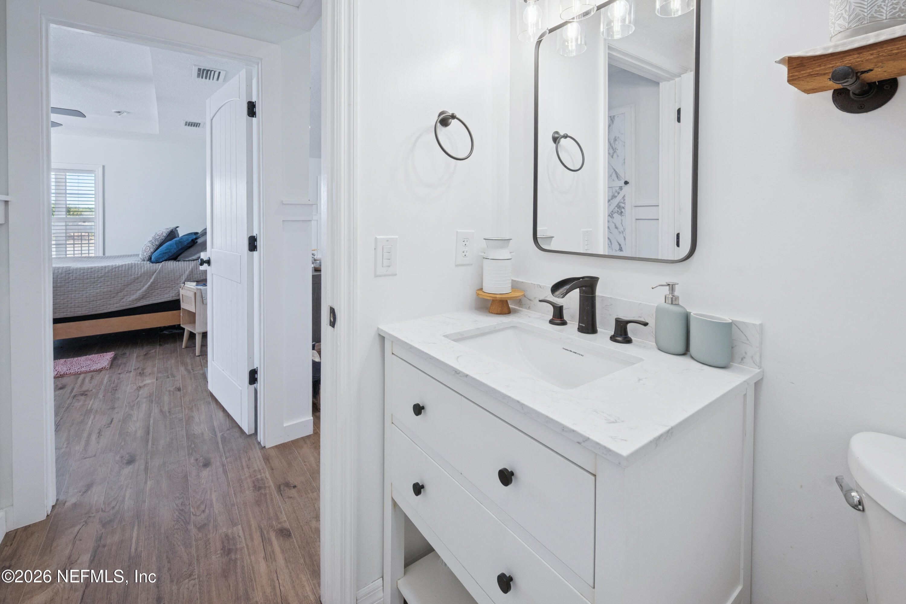 23779 Northwest 225a Road, Unit COUNTY Starke, FL 32091 - Photo 32 of 73 a en suite bathroom with a sink a mirror and a shower