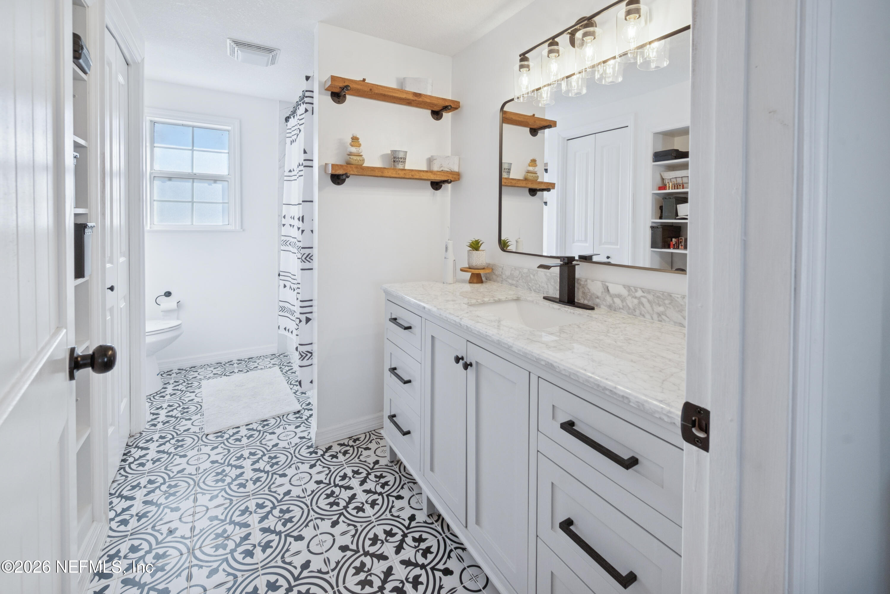 23779 Northwest 225a Road, Unit COUNTY Starke, FL 32091 - Photo 36 of 73 a bathroom with a sink and a mirror