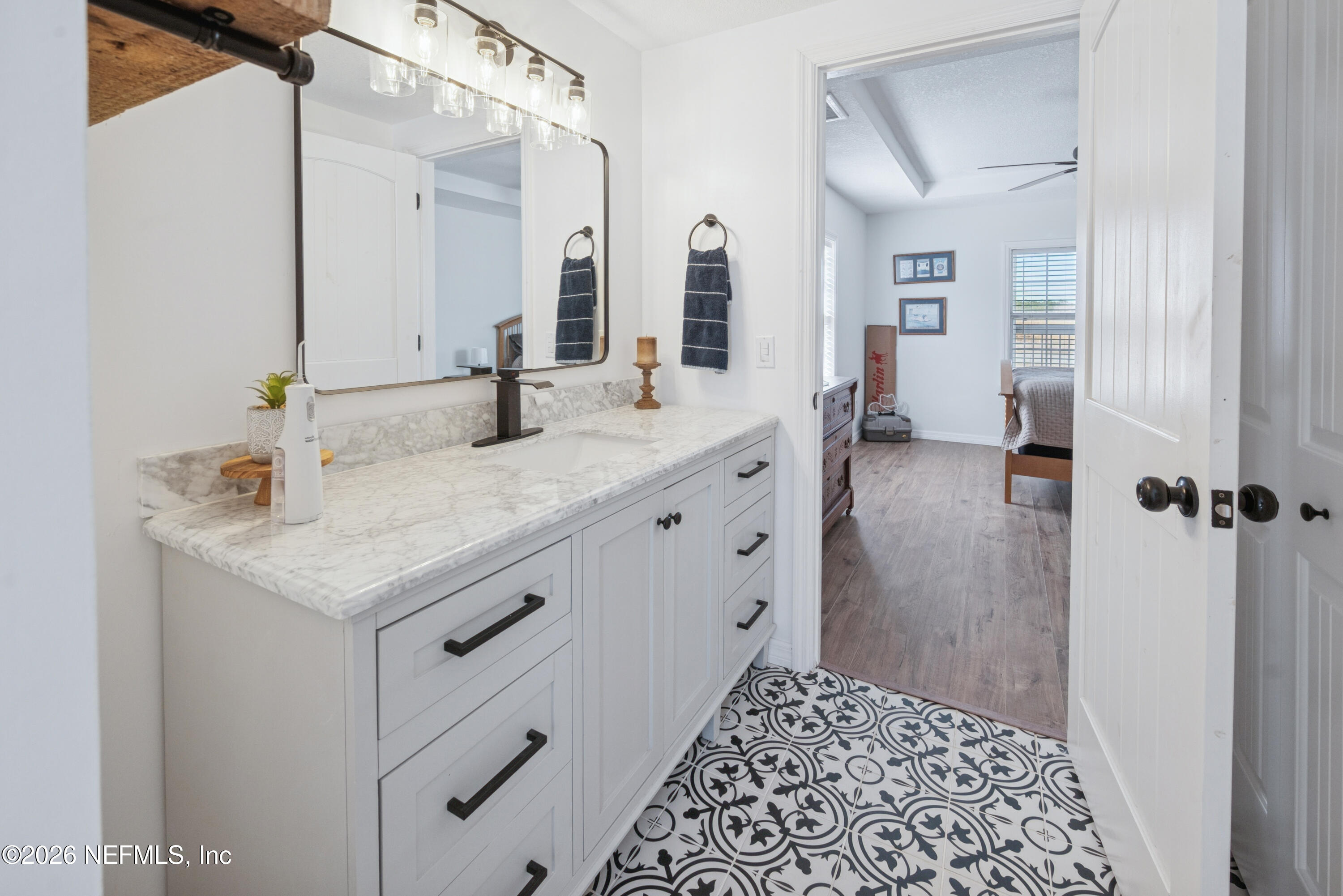 23779 Northwest 225a Road, Unit COUNTY Starke, FL 32091 - Photo 39 of 73 a bathroom with a granite countertop sink and a mirror
