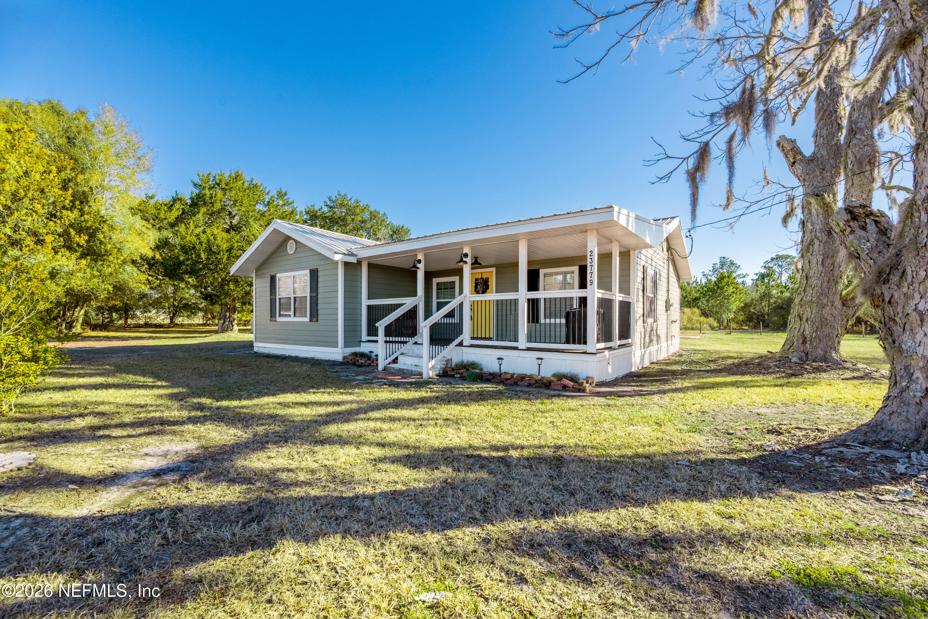 23779 Northwest 225a Road, Unit COUNTY Starke, FL 32091 - Photo 44 of 73 a view of a house with pool and sitting area