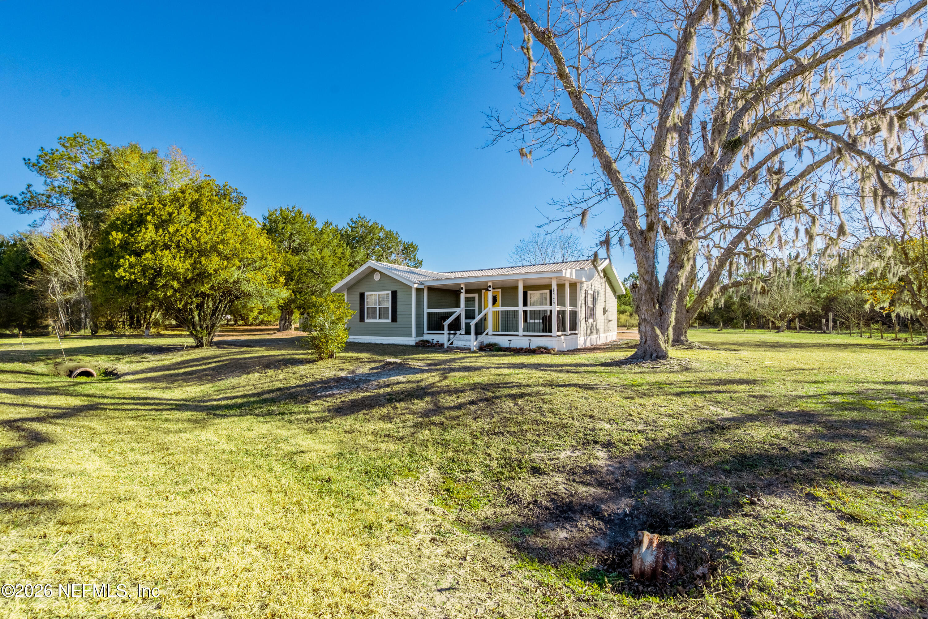 23779 Northwest 225a Road, Unit COUNTY Starke, FL 32091 - Photo 46 of 73 a view of a house with a big yard