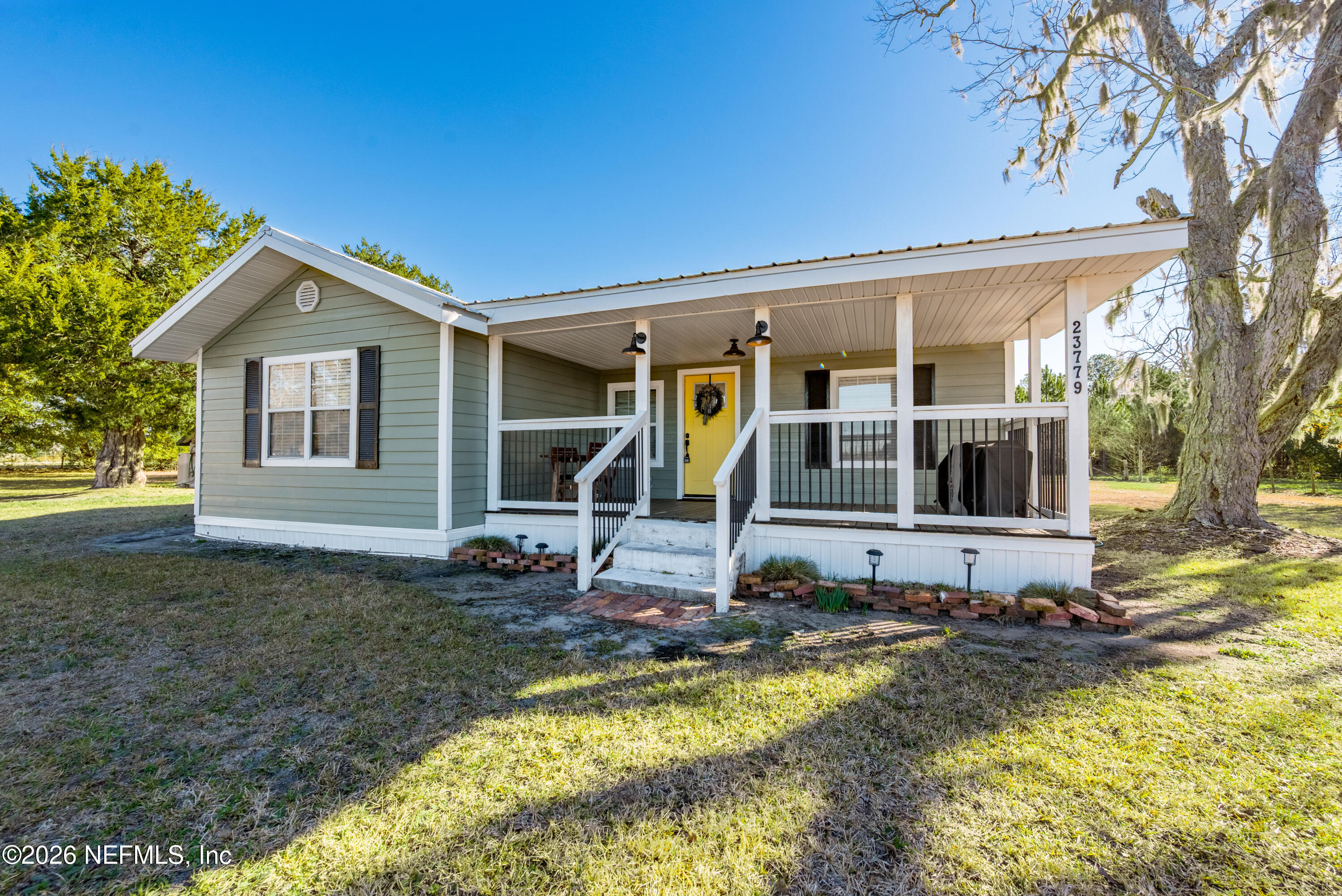 23779 Northwest 225a Road, Unit COUNTY Starke, FL 32091 - Photo 49 of 73 a view of a house with swimming pool next to a yard