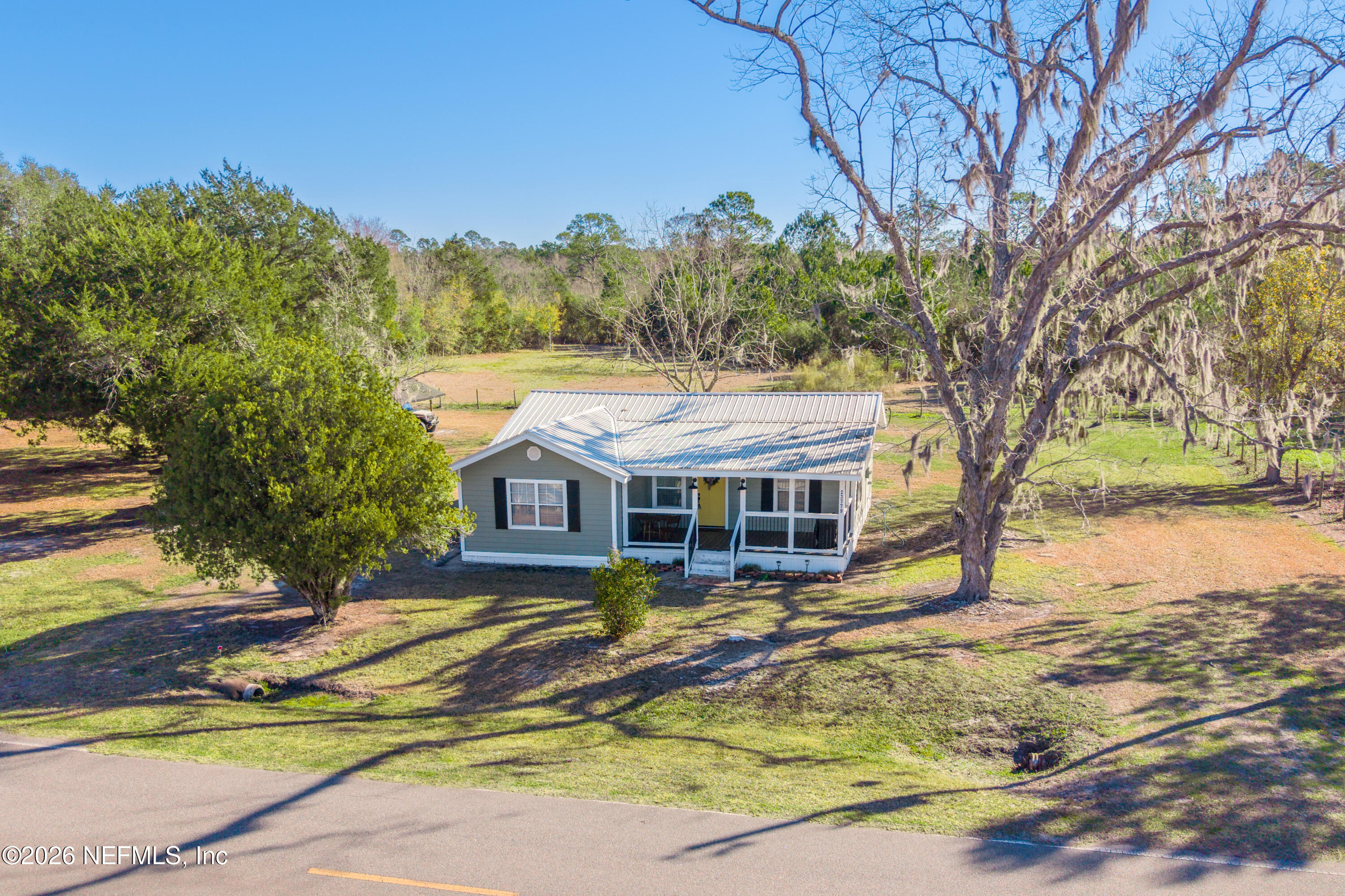 23779 Northwest 225a Road, Unit COUNTY Starke, FL 32091 - Photo 51 of 73 front view of a house with a small yard