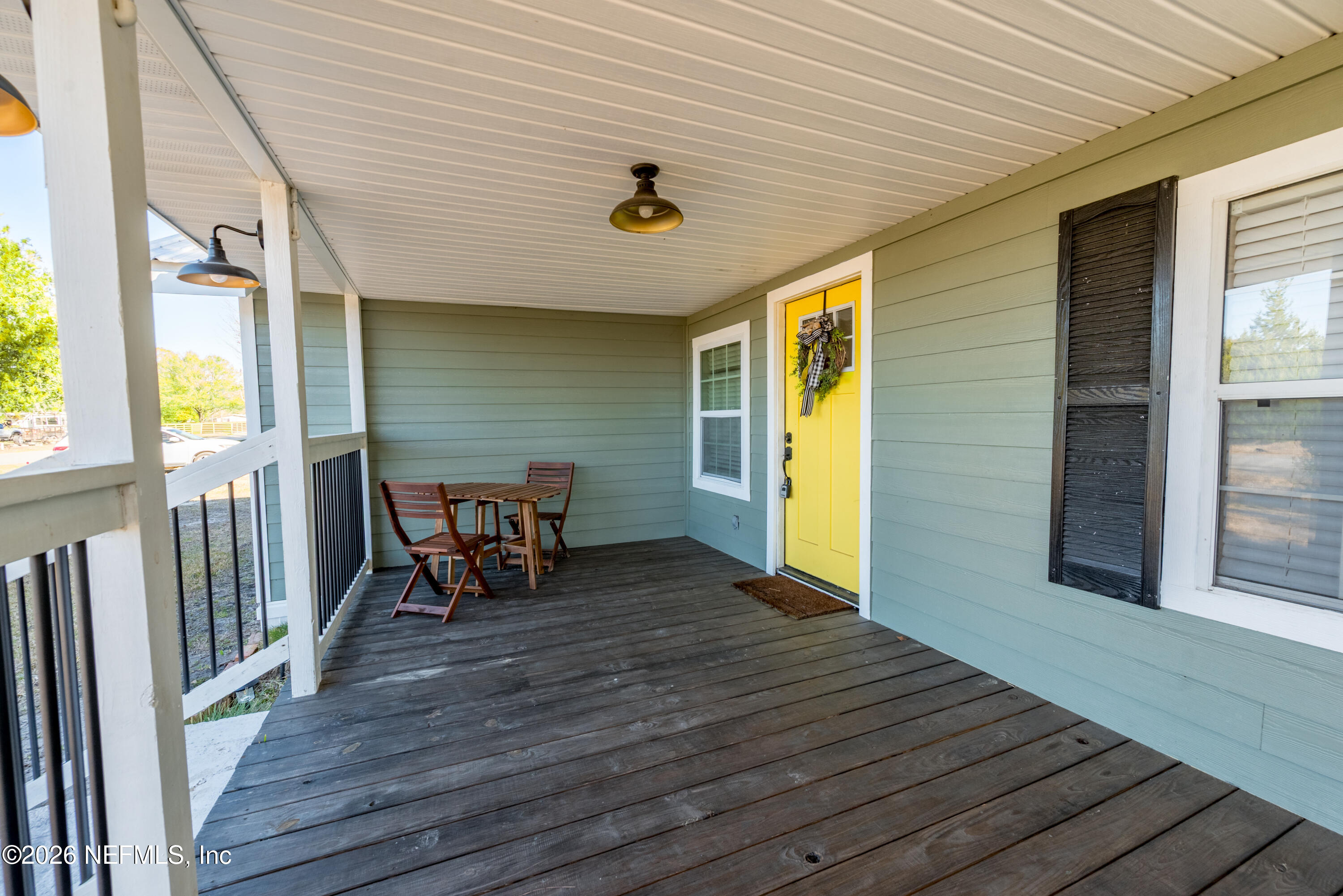 23779 Northwest 225a Road, Unit COUNTY Starke, FL 32091 - Photo 52 of 73 a dining room with wooden floor and outdoor space