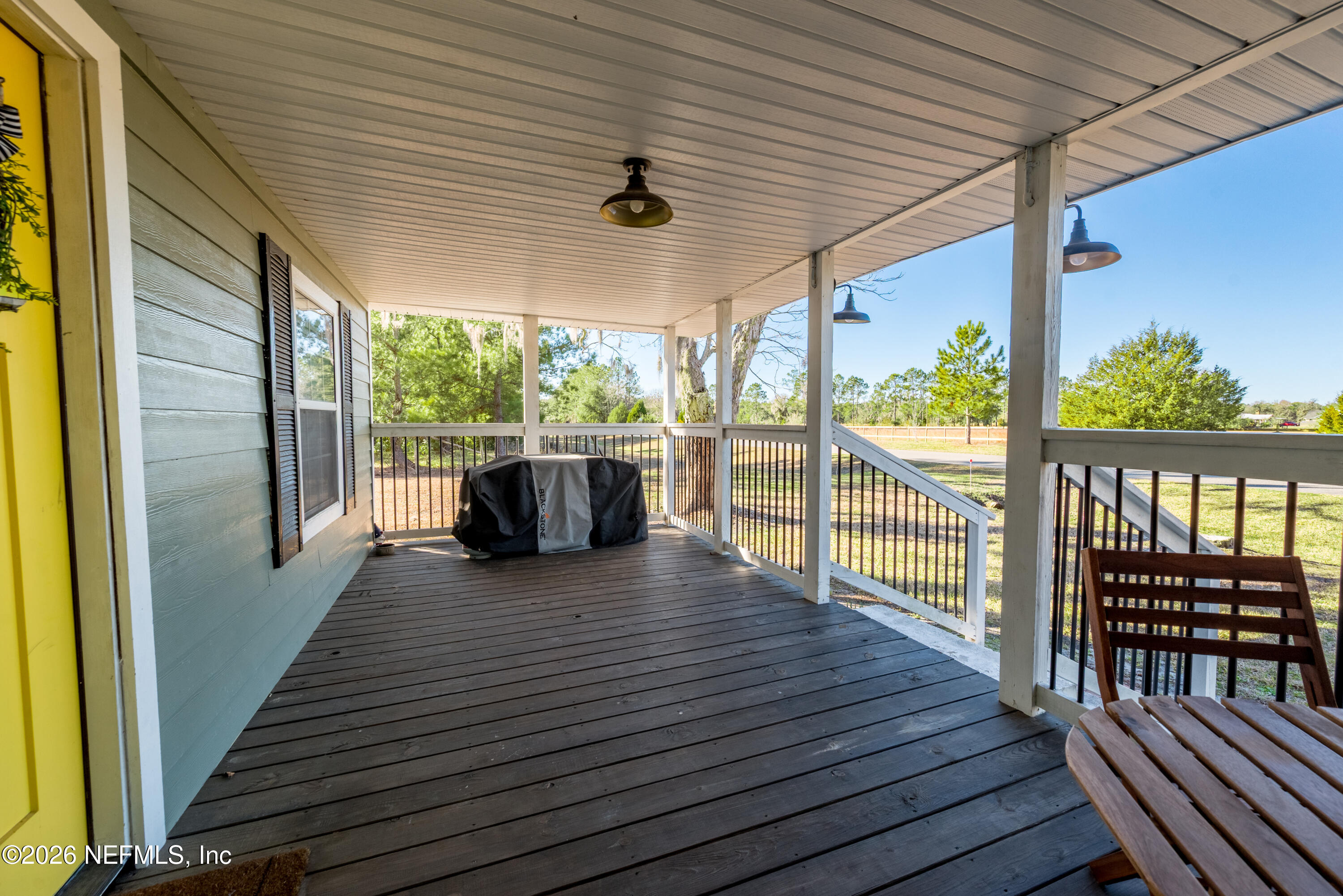 23779 Northwest 225a Road, Unit COUNTY Starke, FL 32091 - Photo 53 of 73 a view of a porch with wooden floor and outdoor space