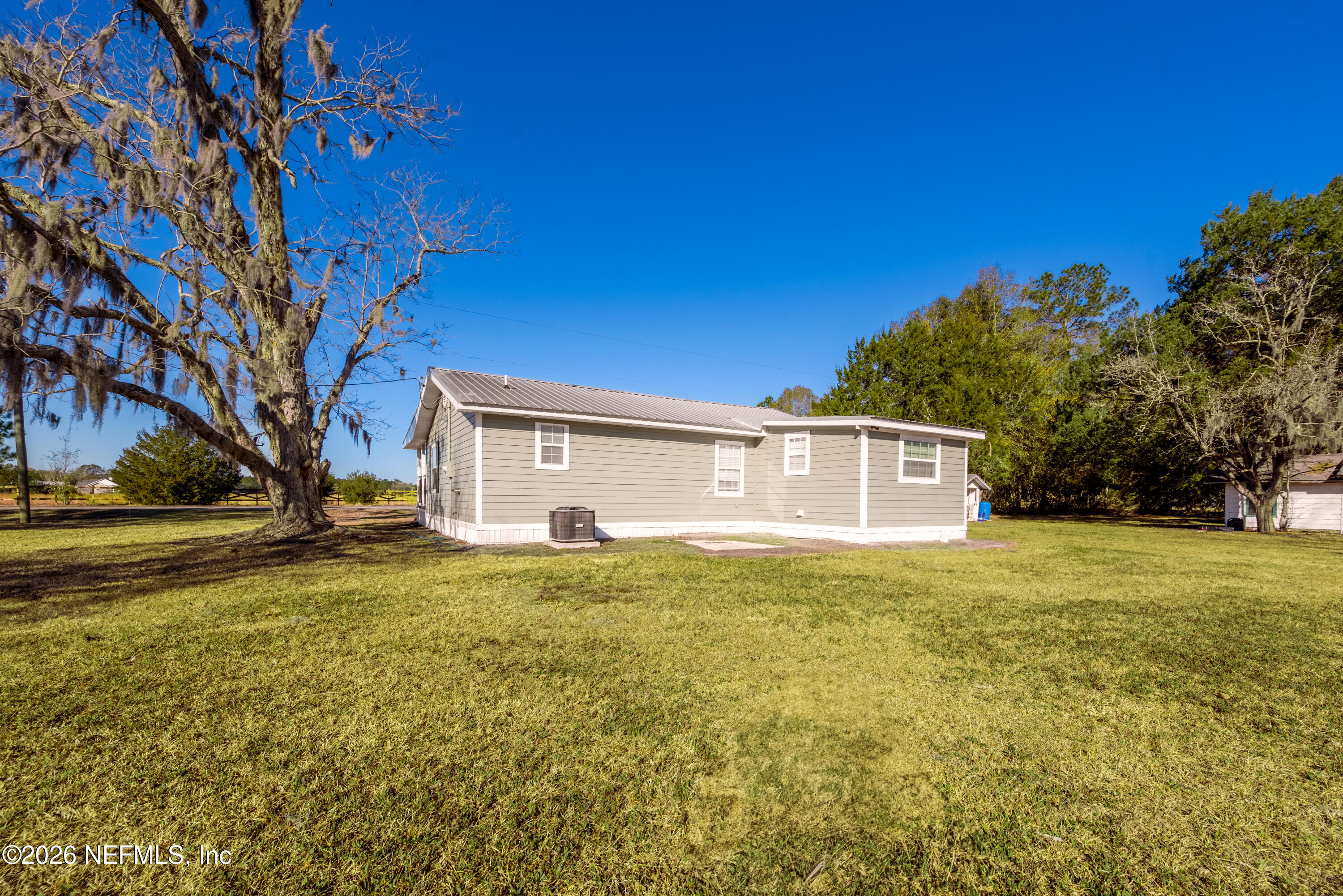 23779 Northwest 225a Road, Unit COUNTY Starke, FL 32091 - Photo 57 of 73 a view of a house with a yard
