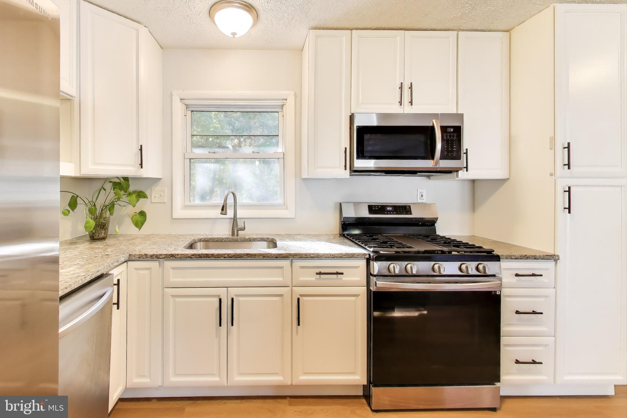 119 Jefferson Road Waldorf, MD 20602 - Photo 11 of 44 a kitchen with stainless steel appliances granite countertop a stove a sink and a microwave