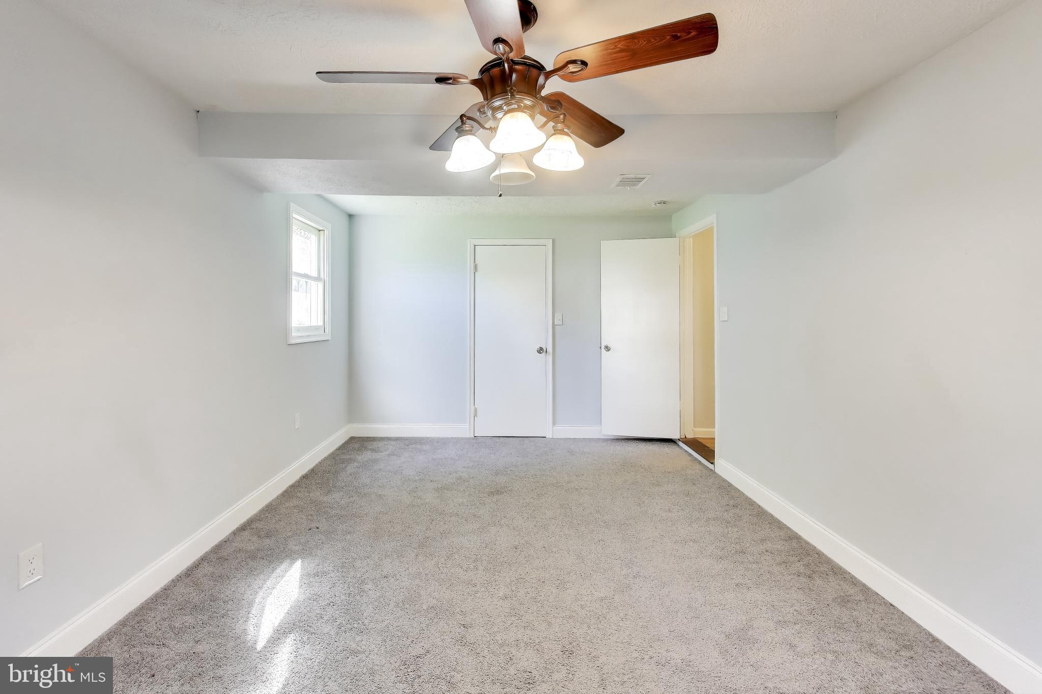 119 Jefferson Road Waldorf, MD 20602 - Photo 25 of 44 an empty room with chandelier fan and windows