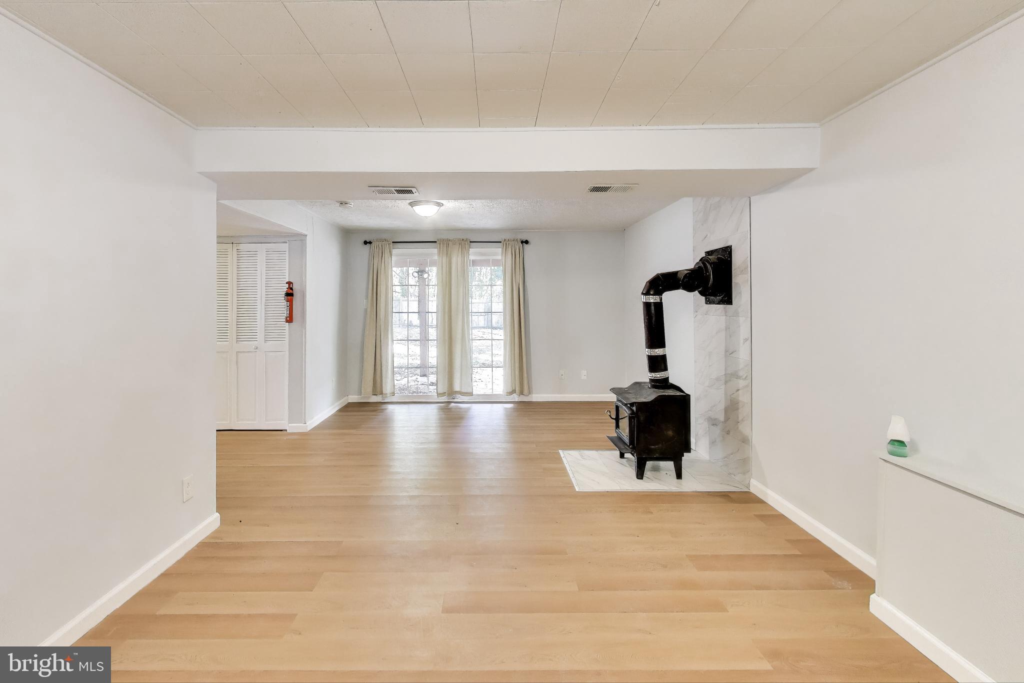 119 Jefferson Road Waldorf, MD 20602 - Photo 27 of 44 a view of an empty room with wooden floor and a window