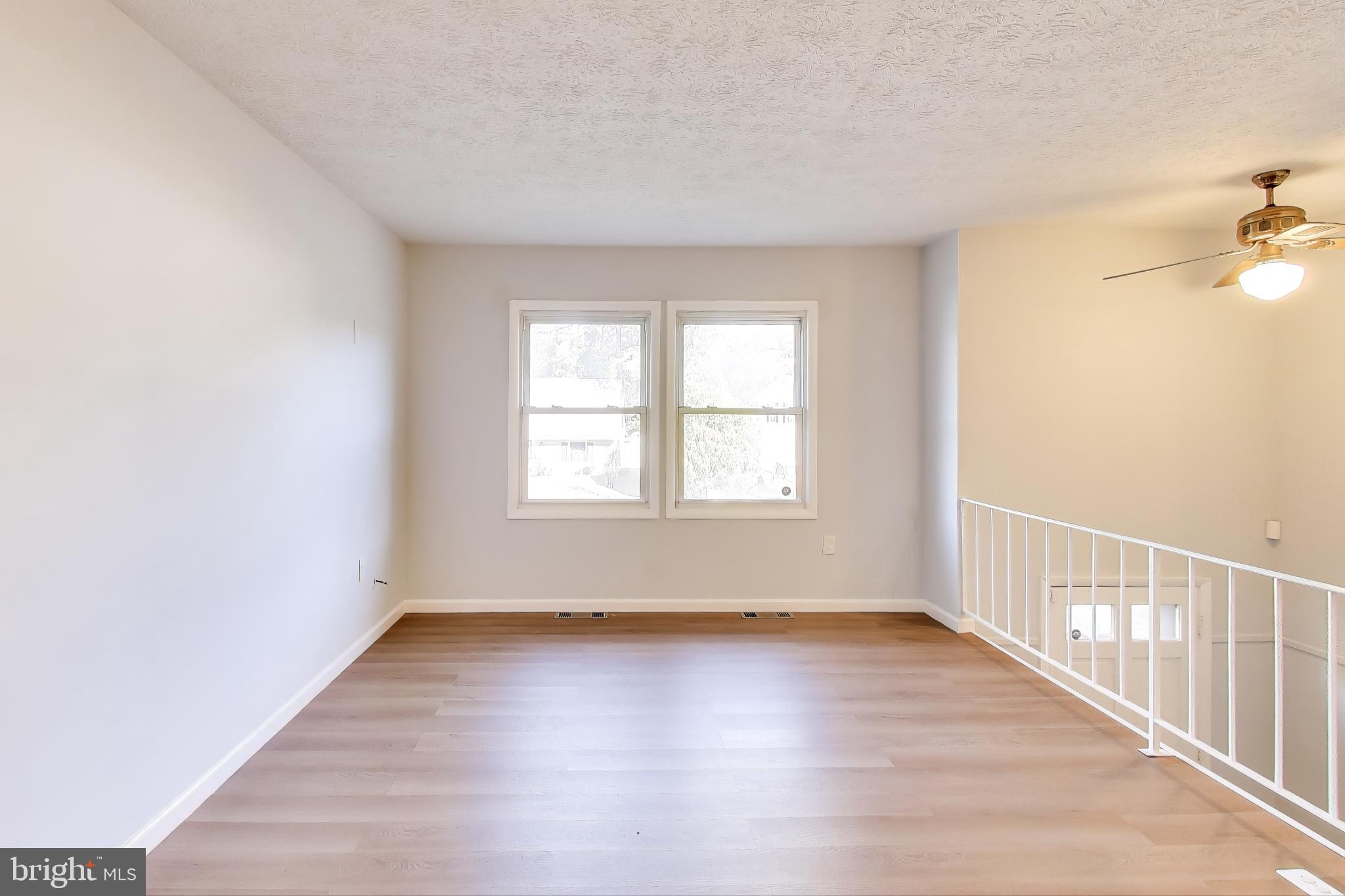 119 Jefferson Road Waldorf, MD 20602 - Photo 6 of 44 an empty room with wooden floor and windows